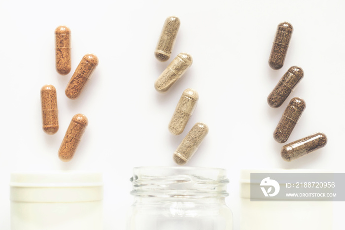 Medicinal capsule spill out of a three plastic bottles