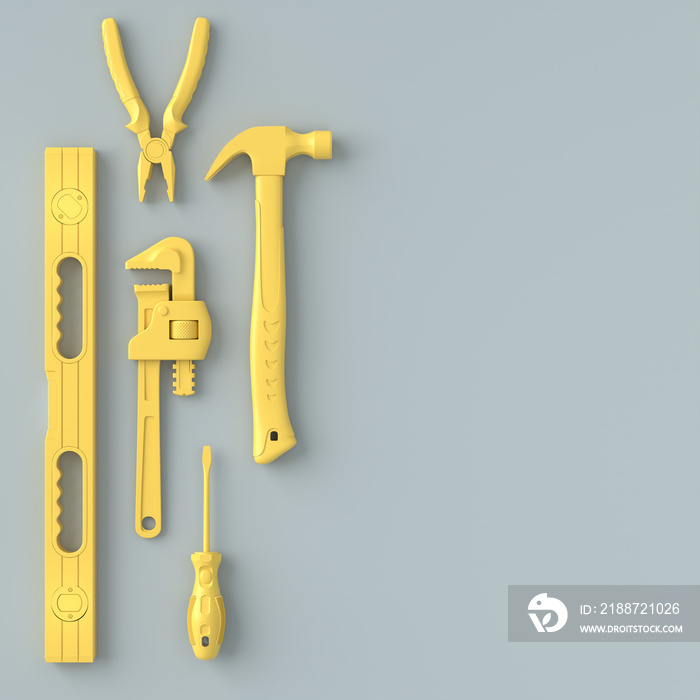 Top view of monochrome construction tools for repair on grey and yellow