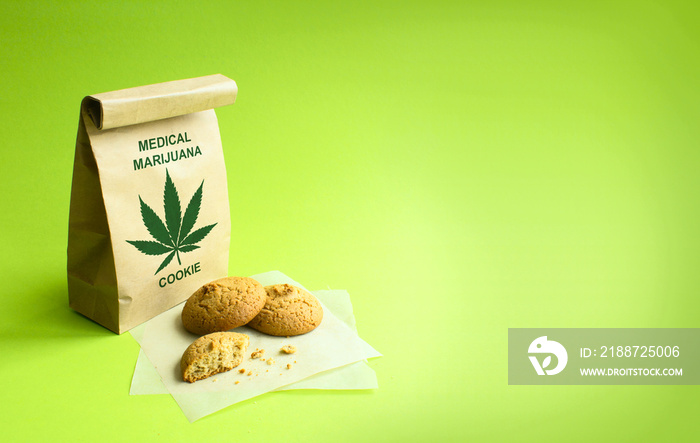 Cookies of medical marijuana in the kraft bag. Green background.