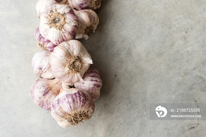 Close up of whole garlics on concrete background (selective focus)