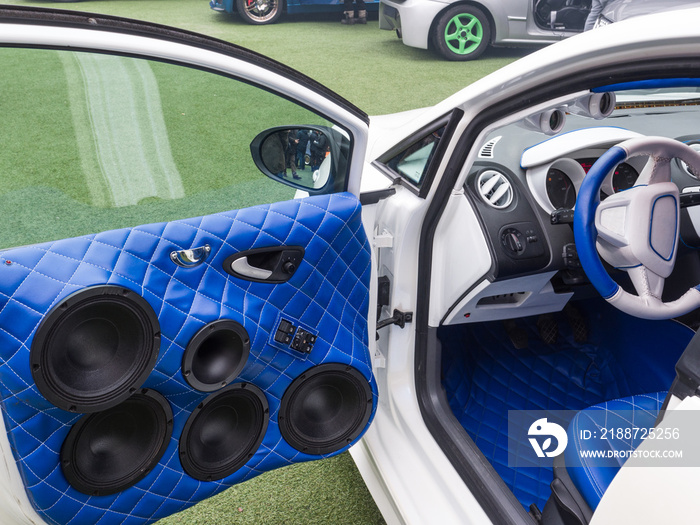 white car with interior upholstered in blue leather and powerful stereophonic system