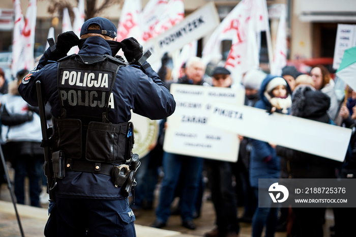 Polish police department securing demonstration on city streets.