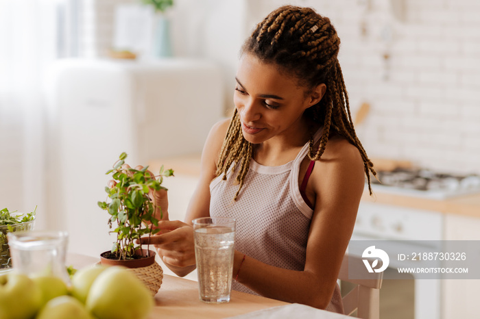 Woman loving green plants taking care of her favorite home plant