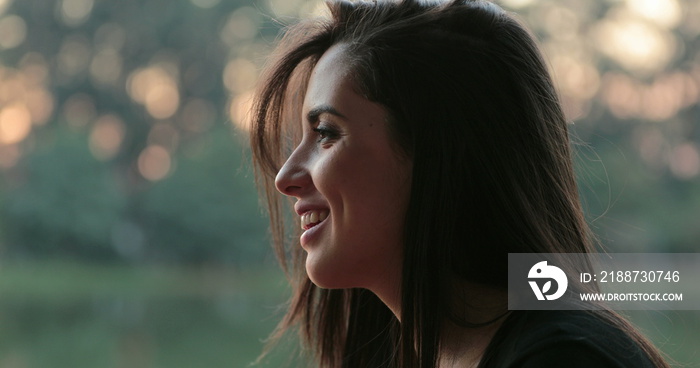 Candid profiles of friends speaking outdoors at the park