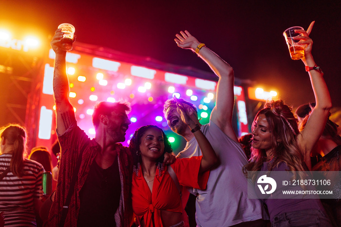 Cheerful crew dancing together and an outdoors festival