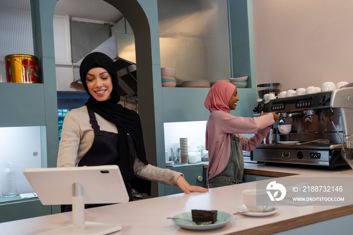 Smiling young women working in cafe