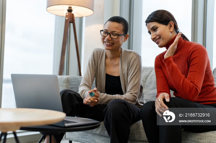 Coworkers having online meeting in office lobby