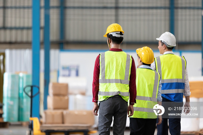 back view factory workers walking in warehouse for start a work