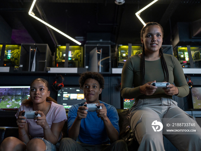 Friends playing video games in gaming club