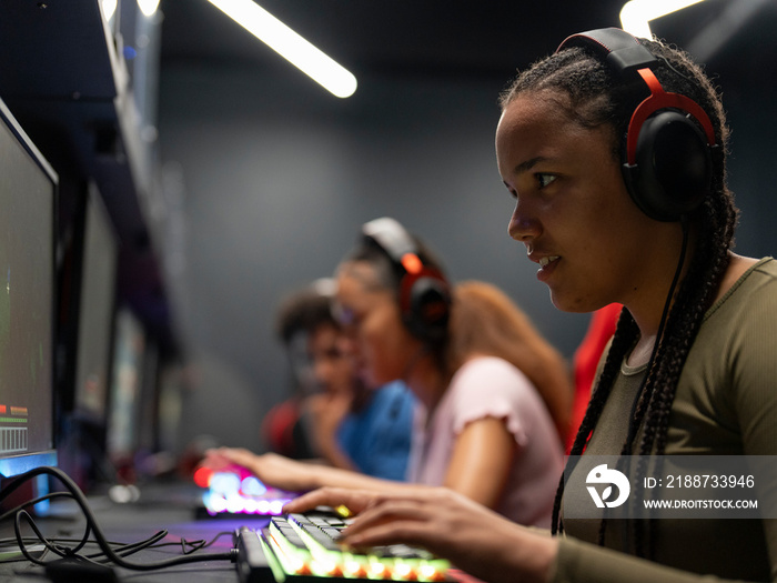 Friends playing video games in gaming club