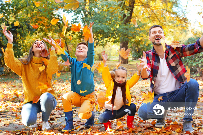 Happy family having fun in autumn park