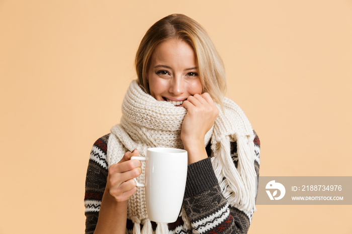 Portrait of a smiling girl dressed in sweater and scarf