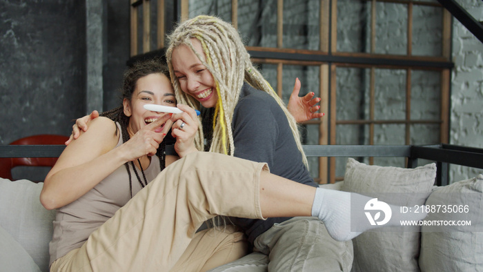 Two lesbian girls are excited to see positive pregnancy test