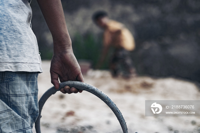 Child labor in building commercial buildings. World Labor Day concept.