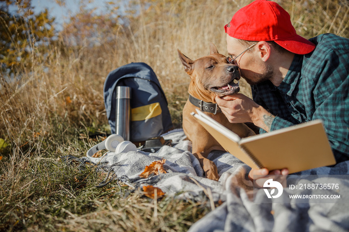 Man whispering kind words to his dog stock photo