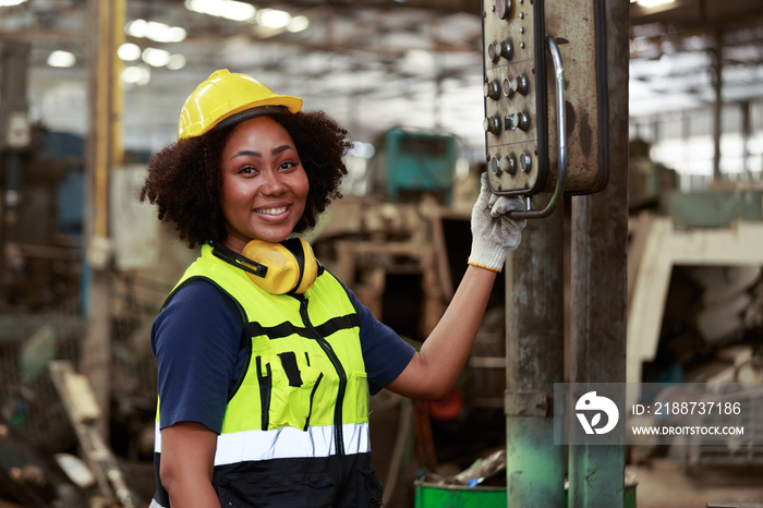 African female engineers American, wear a professional helmet, operate and maintain machines