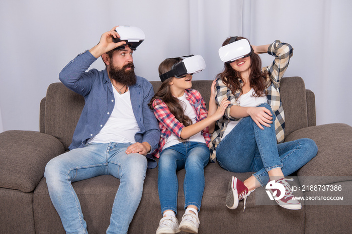 amazed family wear vr glasses sitting on sofa at home, video game