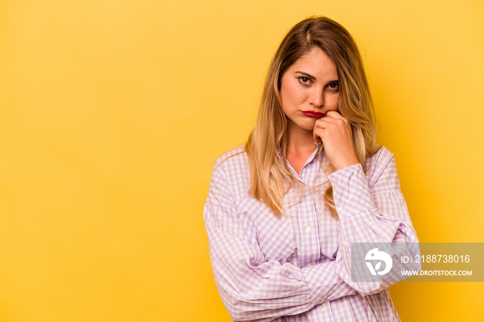 Young caucasian woman isolated on yellow background who feels sad and pensive, looking at copy space.