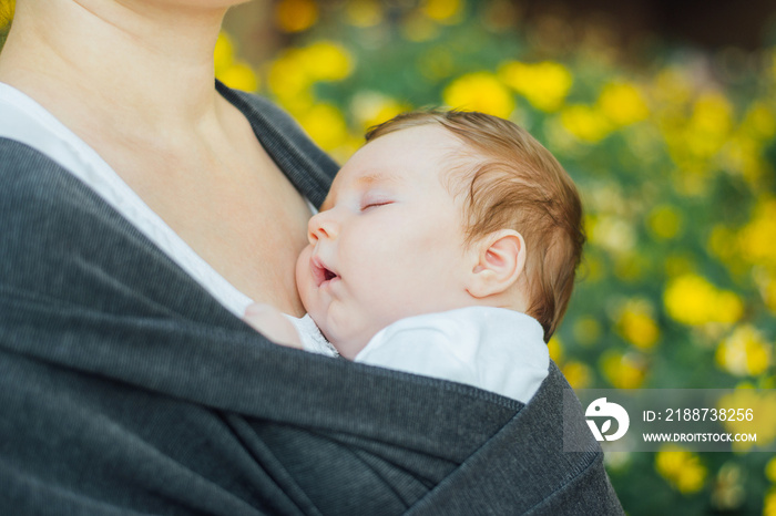 Infant baby sleeping in a wrap