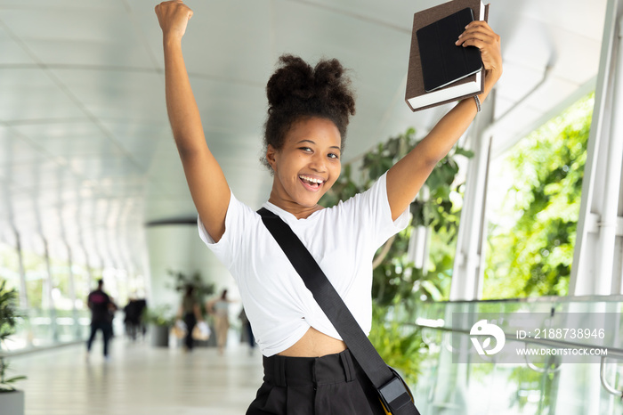 Happy excited young African woman college student having good grade, successful education degree or winning a scholarship program