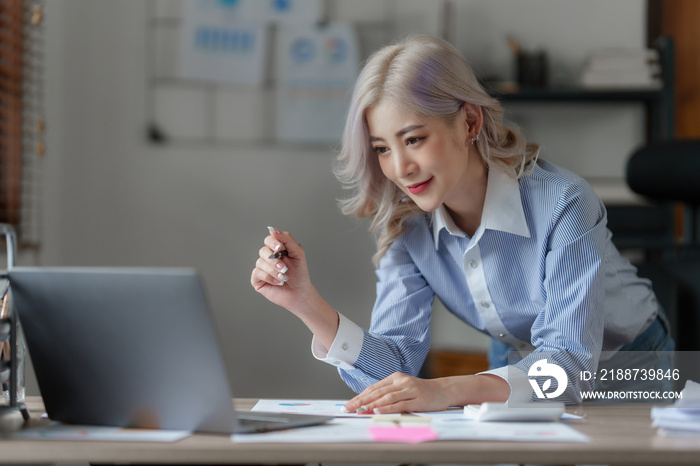 Asian Business woman working to analyze technical price graph and indicator. finance concept