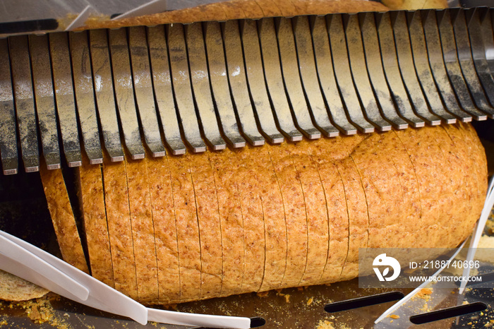 Bread slicer in a supermarket. Industrial bread slicer.