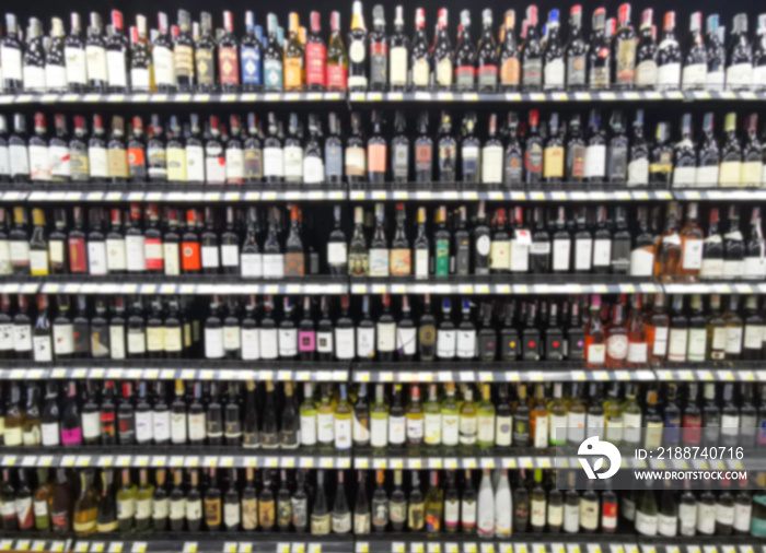 Collection of wines in the store of elite alcohol. Bottles of various wines are beautifully on the rack. Blur background.