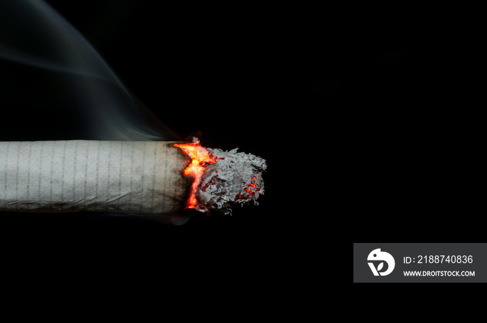 Smoking cigarette on black background