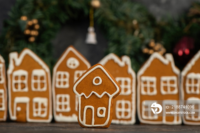 Various christmas gingerbread cookies on dark table with flour