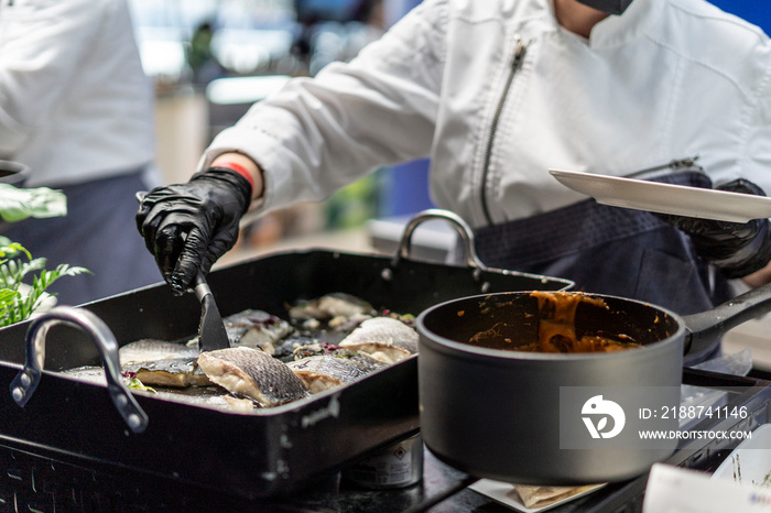 Waiter serving the fish on the plate