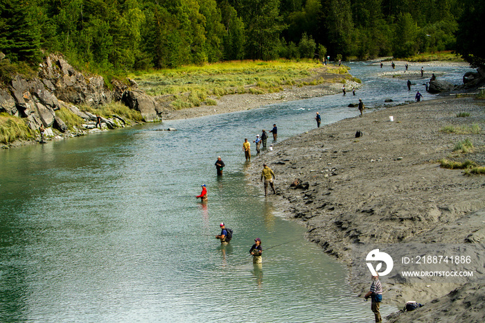 Fishermen, fishing for Sackeye salmon,  lining the bank of the Russian River in Alaska