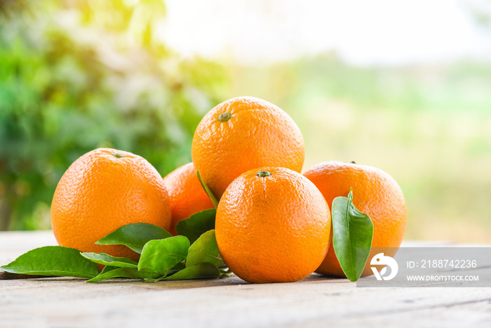 Orange fruits with leaf on wooden and nature background, fresh orange with leaves healthy fruits.