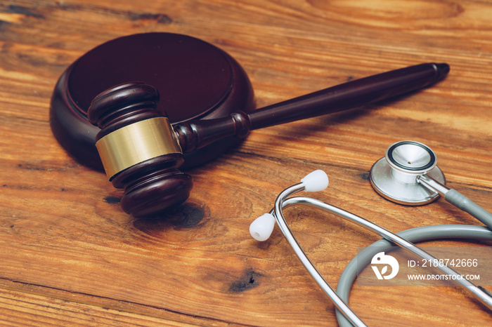 Stethoscope with judge gavel. Concept of healthcare and medicine, malpractice, legal system.