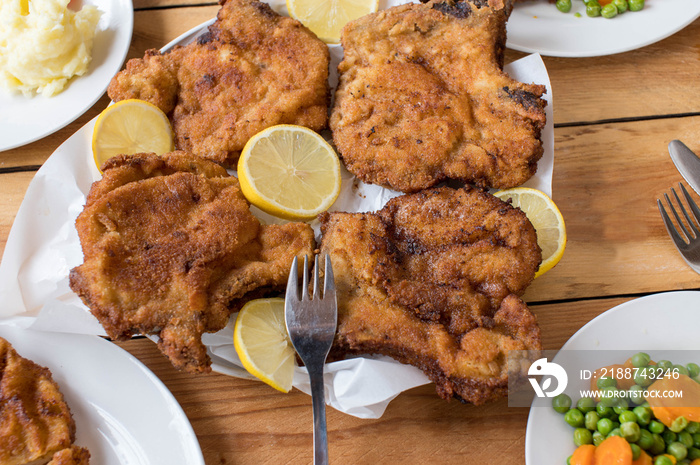 Breaded pork chops on a dinner table