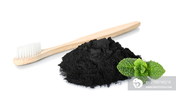 Activated charcoal tooth powder, mint and toothbrush on white background