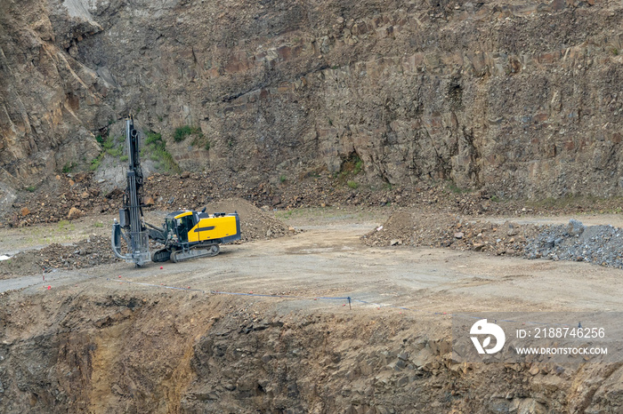 Opencast mining quarry with mining drilling machine. Mining in the granite quarry. Mining industry.