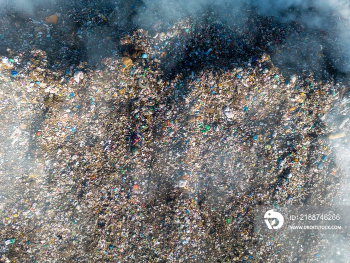 Top down aerial view of burning trash piles in landfill