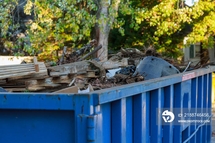 Industrial dumpster filled with debris.