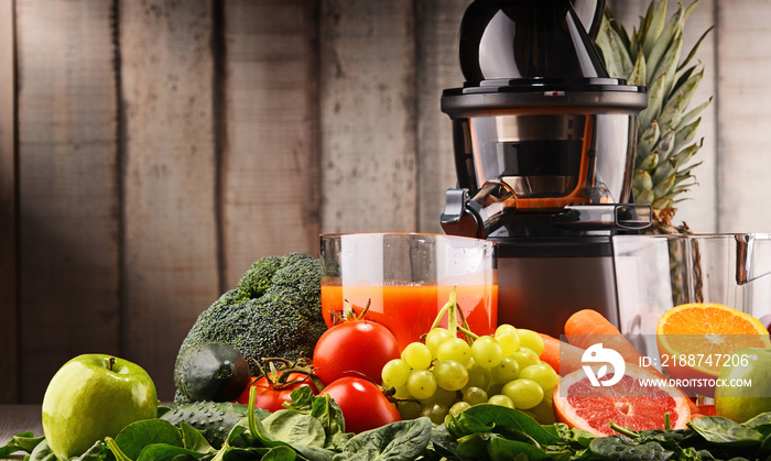 Slow juicer with organic fruits and vegetables.