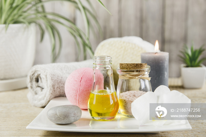 Beauty spa salon menu background minimal set. Bathroom products on light minimal wooden background. Harmonic luxury lifestyle concept. Towel, candles, bath salt, aroma massage oil in bottle.