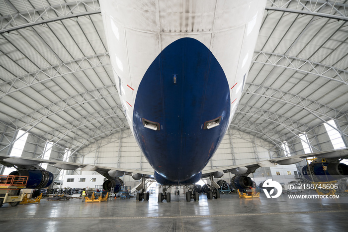 big boeing parked in a hangar