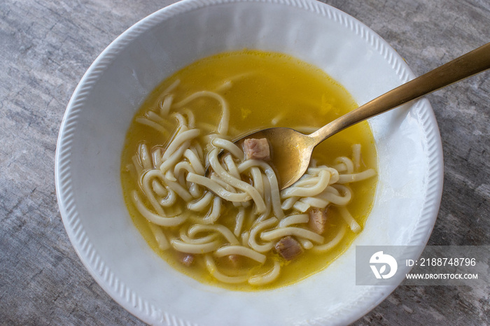 bowl of comfort food of chicken and noodle soup from a can top view