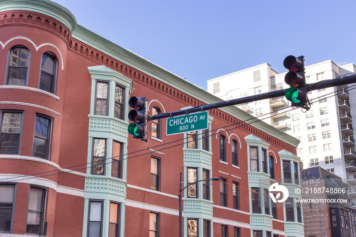 Chicago Ave. street sign in front of vintage building in uptown Chicago