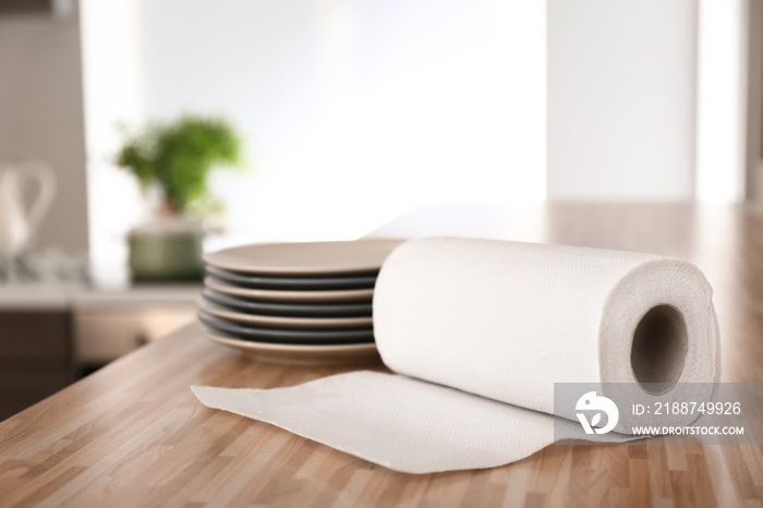 Roll of paper towels with plates on kitchen table