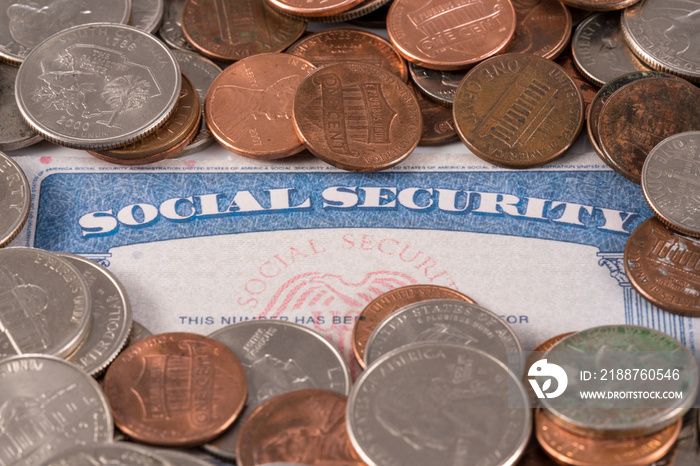 USA social security card with coins and cash to show funding crisis in the trust fund