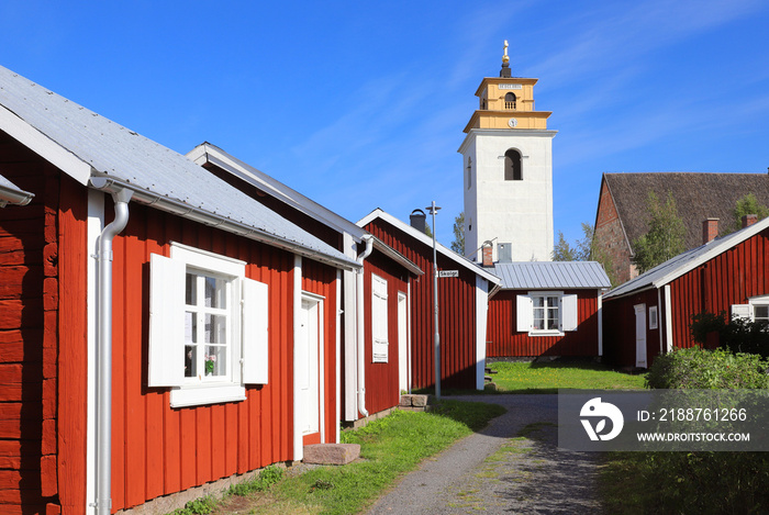 Old red painted cabins in front of the church in the Gammelstad church town.