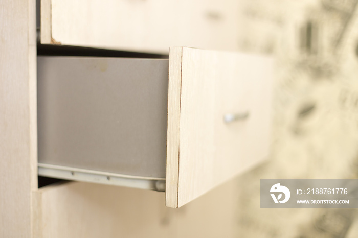 cupboard with opened empty drawer