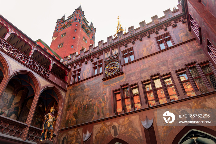 Outdoor low angle view of inner courtyard in Basel Town hall located at Marktplatz , with iconic art painting on red background exterior wall in Basel, Switzerland.