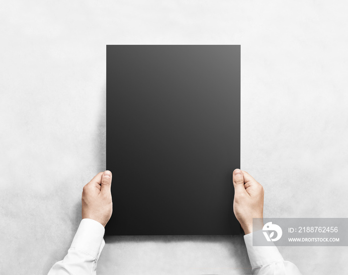 Hand holding black blank poster mockup, isolated. Arm in shirt hold dark broadsheet template mock up. Affiche bill surface design. Broadside pure print display show. Sticking a3 poster on the wall.