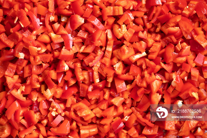 Chopped paprika or red sweet pepper cuts background. Diced bell pepper. Selective focus.